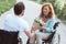 Amazed woman in wheelchair receiving flowers from boyfriend