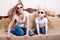 Amazed young beautiful woman with blond little girl sitting watching 3D movie in 3D glasses with real life special effects