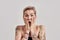 Amazement. Portrait of amazed tattooed woman with short hair looking amazed or shocked at camera with open mouth
