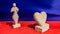 Amazigh white stone statues sculpture of love, on red table with a blue silk background