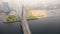 Amazing aerial cityscape view, traffic on cable bridge over Daugava in Riga old town under thick fog on autumn day.