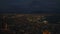 Amazing aerial evening shot of city. Illuminated streets and harbor. Silhouette of Mount Vesuvius in distance. Naples