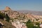 Amazing aerial landscape view of ancient Ortahisar cave city. Blue sky background. Popular travel destination in Turkey