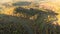 Amazing aerial panorama from drone over a river, fall forest, hill and village