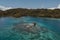 Amazing Aerial Shot of a Luxurious Cottage in the Middle of the Blue Ocean Water