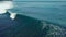 Amazing aerial shot of a professional surfer riding a seamless barreling waves.