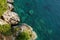 Amazing aerial top drone view of coast of Adriatic sea. Top down view of picturesque rocks and pine trees. Sveti Stefan is a