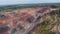 Amazing aerial view on a huge mining quarry with roads and trees around it, 4k