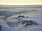 Amazing aerial view of misty swiss alps and clouds above the mountain peaks from airplane