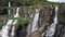 Amazing aerial view of waterfall in Asia with a white lady buddha in the jungle.