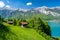 Amazing alpine view on Brienzersee lake with wooden hut during sunny day in Switzerland