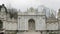 Amazing architecture of Dolmabahce gate and tourists walking nearby