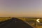 Amazing asphalt curved road with fields and traffic sign view in countryside on sunset , sunny day