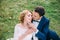 Amazing attractive young couple in wedding day. the bride in a cute white dress, the groom in a blue fashionable