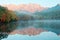 Amazing autumn lake scenery of Kagami Ike Mirror Pond in morning light with symmetric reflections of colorful fall foliage