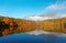 Amazing autumn lake scenery of Kagami Ike Mirror Pond in morning light with symmetric reflections of colorful fall foliage