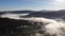 Amazing autumn landscape in Carpathian Mountains. Morning fog over valley, coniferous forests on the slopes