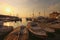 Amazing autumn landscape of harbor during sunset. Sailboats and yachts moored in marina of Koper and reflected in quite water.