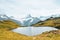 Amazing Bachalpsee in the Swiss Alps photographed with famous mountain peaks Eiger, Jungfrau, and Monch. Lake and Alpine landscape