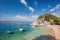 Amazing beach with boats against azure sea in Brela, Makarska, Dalmatia, Croatian coast