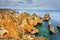 Amazing beach at sunrise. Algarve in the south of Portugal is a travel vacation destination for many tourists. Beautiful cliffs, c