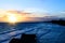 Amazing beach at sunrise or sunset. Background of a seashore with palm trees and blue water in the early morning. Multicolored