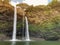 Amazing beautiful big,giant,huge twin Wailua waterfalls on Kauai island, Hawaii. rock face in rainforest with copy space. sunset