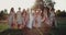 Amazing beautiful bride with her team girls with boho style dresses walking in amazing sunset. Slow Motions