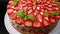 Amazing beautiful hand decorated homemade strawberry Fraisier cake rotates. Tasty, fresh, appetizing dessert close-up