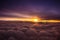 Amazing and beautiful sunset above the clouds with dramatic clouds