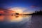 Amazing beautiful sunset with silhouette wooden jetty and coconut tree