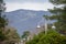 Amazing beautiful view of mountains with inscription `Gelendzhik` from city alley with beautiful lanterns and green trees