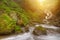 Amazing beauty of Alps mountains waterfall. Summer waterfall in Alps with soft sunlight at evening