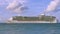 Amazing beauty  Atlantic ocean turquoise water surface. Big cruise boat merging with blue sky and white clouds. Aruba island.