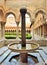 Amazing Benedictine Cloister in Monreale, Sicily, Italy. In the foreground a decorated fountain with Arab and Norman designs