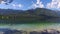 Amazing Bohinj Lake in morning. Duck swims and flies in deep clear water with fish. Gorgeous landscape of Julian Alps. Slovenia.