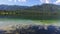 Amazing Bohinj Lake in the morning. Panoramic view. Deep clear water with fish and gorgeous landscape of Bohinj valley. Slovenia.