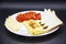 Amazing breakfast with tasty omelet, tomatoes, cheese, bread and sauce on the white plate. Delicious omelet made like rolle, other
