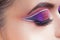 Amazing Bright eye makeup. Eye shadow with a purple tint and an unusual white arrow