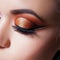 Amazing Bright eye makeup with a spectacular arrow. Brown and gold tones, colored eyeshadow