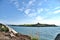 Amazing bright view of Dalkey Island seen from Sorrento Point, Dalkey, Dublin, Ireland. Blue sky and sunny day. Clover flowers