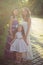 Amazing Brunette blond chestnut blue eyes sisters girls wearing stylish white purple dress enjoying vacation together spring sunny