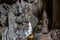Amazing buddha statues in beautiful cave, holy natural buddhist sanctuary in Thailand