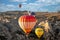 Amazing Cappadocia rocky landscape and balloons at sunrise, view of the valley and canyons