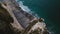 Amazing cinematic aerial shot of happy romantic couple watching sunset sea sitting on top of famous Normandy shore cliff