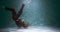 Amazing cinematic shot of young beautiful dancer woman doing modern dance moves upside down under water slow motion.