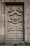 Amazing classic gray wooden door with decorative details. Front view