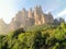 Amazing cliffs on Mountain Montserrat in Catalonia Spain lightened by sunbeams. Beautiful mountain landscape on a sunny summer