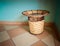 Amazing closeup view of old vintage woven garbage bean basket on ceramic tile floor