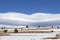 Amazing clouds on blue sky and desert snowy hill.